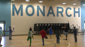 Students at Monarch School do stretches during physical education class on Oct. 11, 2013.