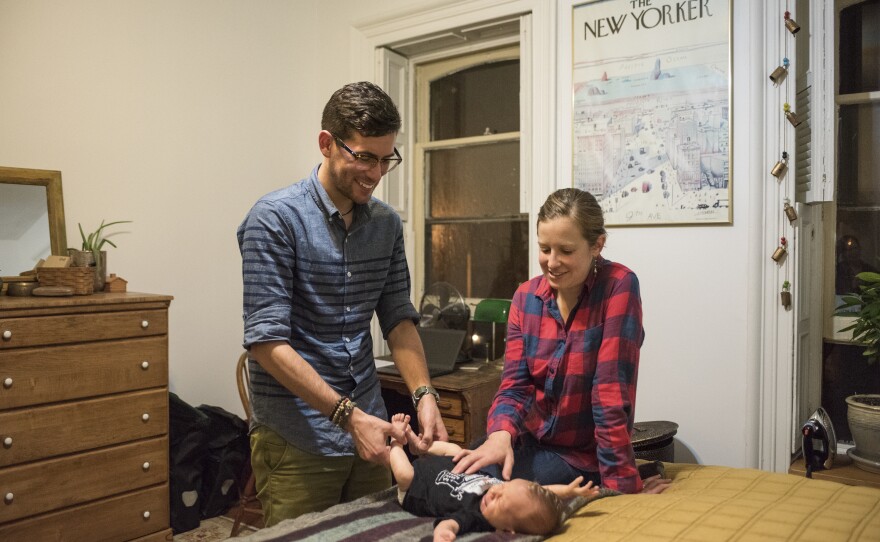 Taylor and Tiffany Delhagen play with their son, Rumi.