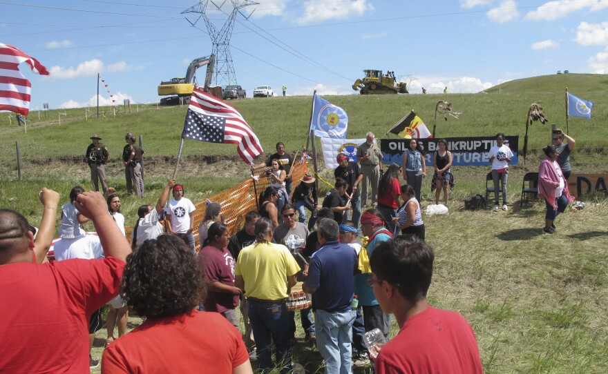 In August 2016, demonstrators rally near the Standing Rock Sioux Reservation. That same month, a subsidiary of the company building the pipeline, accused protesters of halting construction activities.