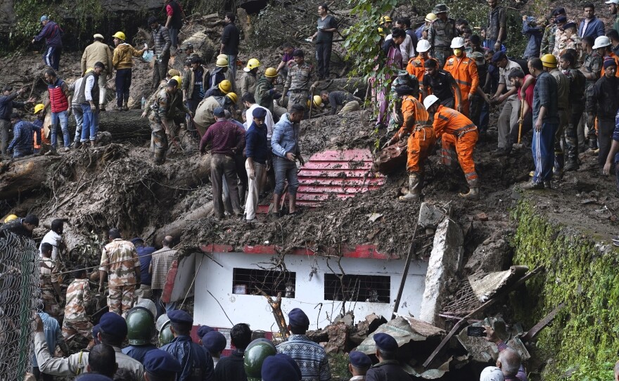 Rescuers search for people after a landslide in India in August that was caused by torrential rains. Climate-driven disasters are particularly destructive in places that are not wealthy, and such disasters can set off cycles of destruction, debt and further vulnerability.