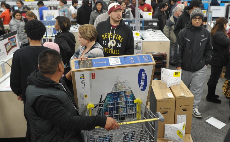 Shoppers line up in a Best Buy store in Rockville, Md., during a Black Friday sale. Thanksgiving weekend sales jumped nearly 13 percent from last year, the National Retail Federation says.