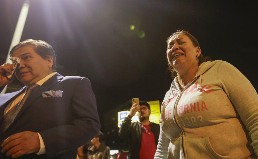 Supporters of presidential candidate Fernando Villavicencio cry outside the hospital where he was taken after he was shot to death while at a campaign rally in Quito, Ecuador, Wednesday, Aug. 9, 2023.