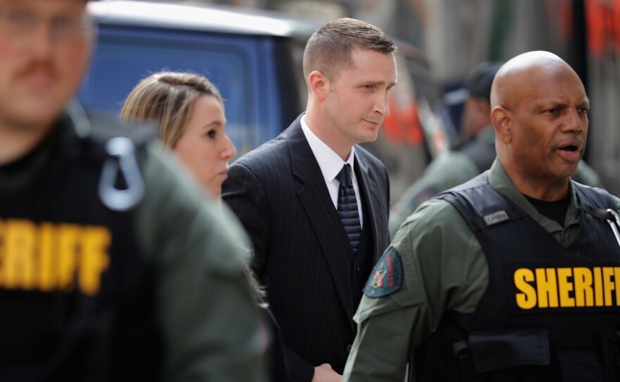 Officer Edward Nero (center) arrives at court in Baltimore on Monday. Nero has been found not guilty of multiple misdemeanor charges in the Freddie Gray case.