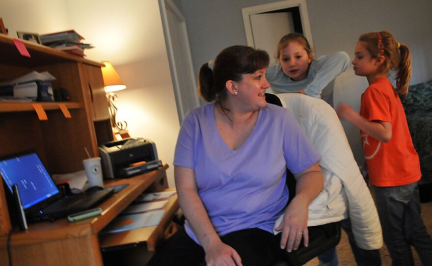 Stumpf spends time with her daughters while getting some work done in her home office.