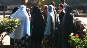 Nima Ali Yusuf's family gather around her defense attorney after a hearing in November 2010.