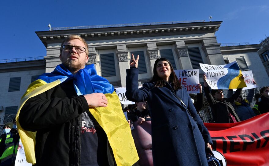 Activists hold banners and shout slogans during an "Empire must die" rally outside the Russian embassy in Kyiv on Feb. 22.