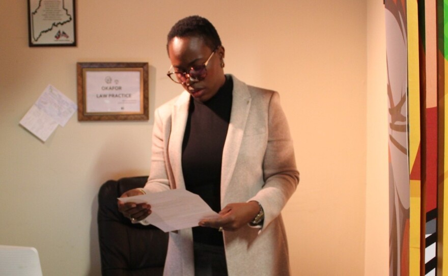 Angela Okafor at her small immigration law office located inside her store in Bangor, Maine. Okafor, who has a law degree from her home country of Nigeria and passed the New York bar exam, opened an immigration law practice three years ago.