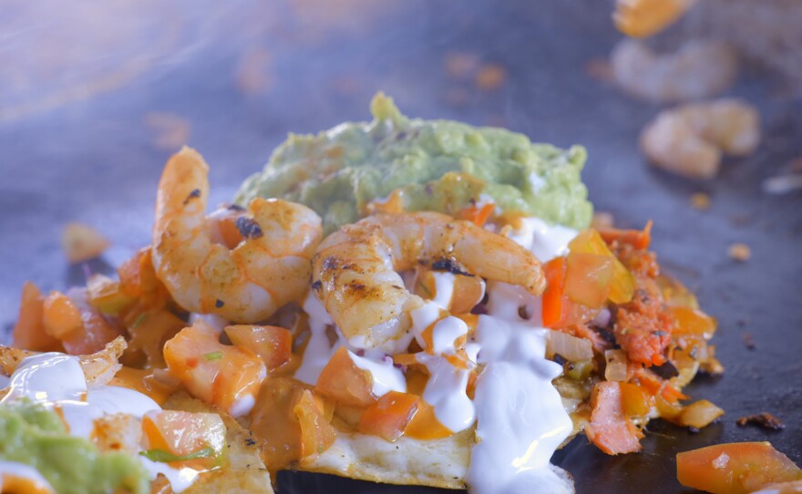 Shrimp tacos being cooked at the Carreta Los Compadres taco stand.