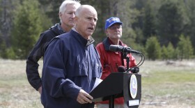 Gov. Jerry Brown, center, answers a question concerning the executive order he signed requiring the state water board to implement measures in cities and towns to cut water usage by 25 percent compared with 2013 levels, at Echo Summit, Calif., April 1, 2015. 