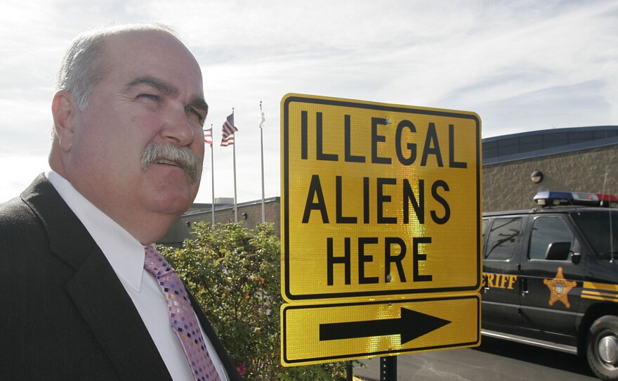 Butler County Sheriff Richard Jones stands next to a illegal aliens sign he had placed in the parking lot of the Butler County Sheriff's Department, Nov. 3, 2005, in Hamilton, Ohio.