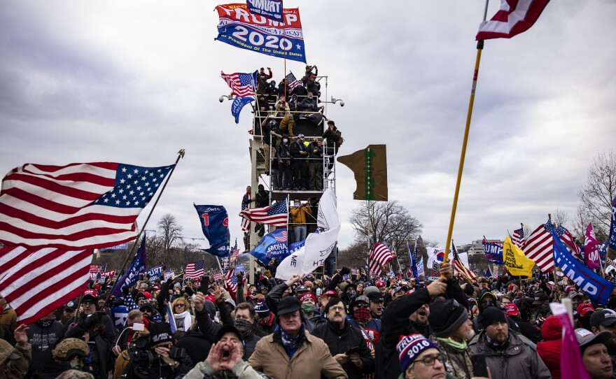 Pro-Trump supporters storm the U.S. Capitol following a rally on Jan. 6. So far, military veterans account for about 15 percent of those criminally charged in the Capitol riot, according to an NPR analysis.
