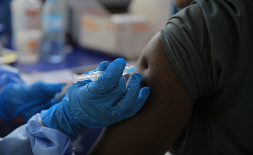 A health care worker administers a dose of Ervebo vaccine against the Ebola virus in Beni, North Kivu province, eastern Congo, on Oct. 16.