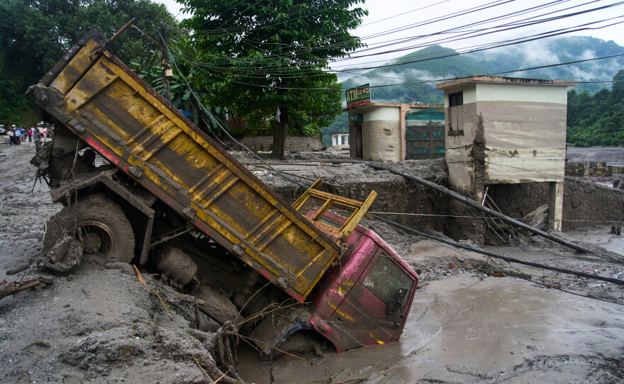A vehicle is seen in the aftermath of flash floods in Devighat in the Nuwakot district in Nepal