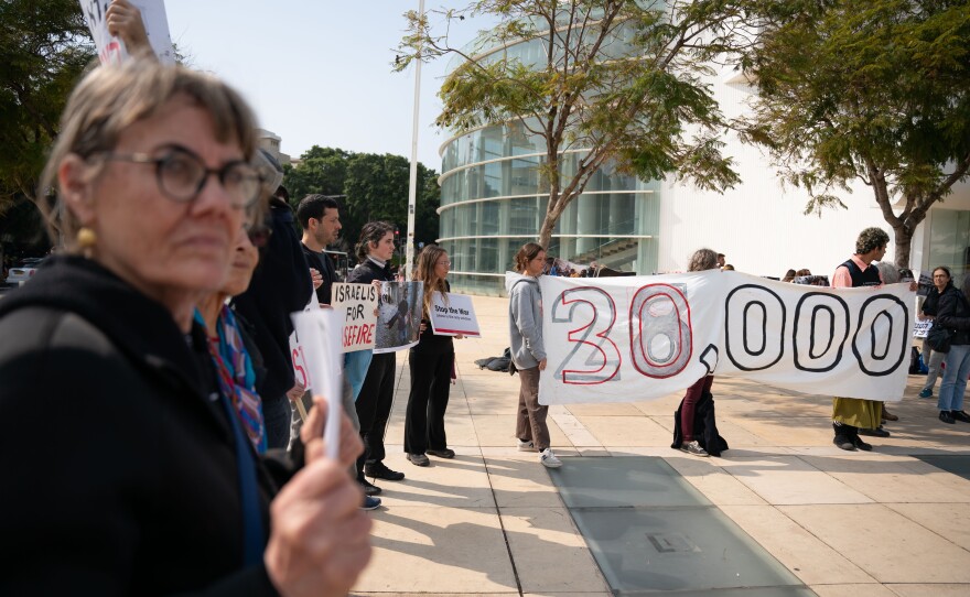 Israeli demonstrators hold an anti-war protest on Feb. 27 in Tel Aviv, Israel, with signs that say 30,000 to signify the Palestinian death toll in Gaza since Oct. 7.