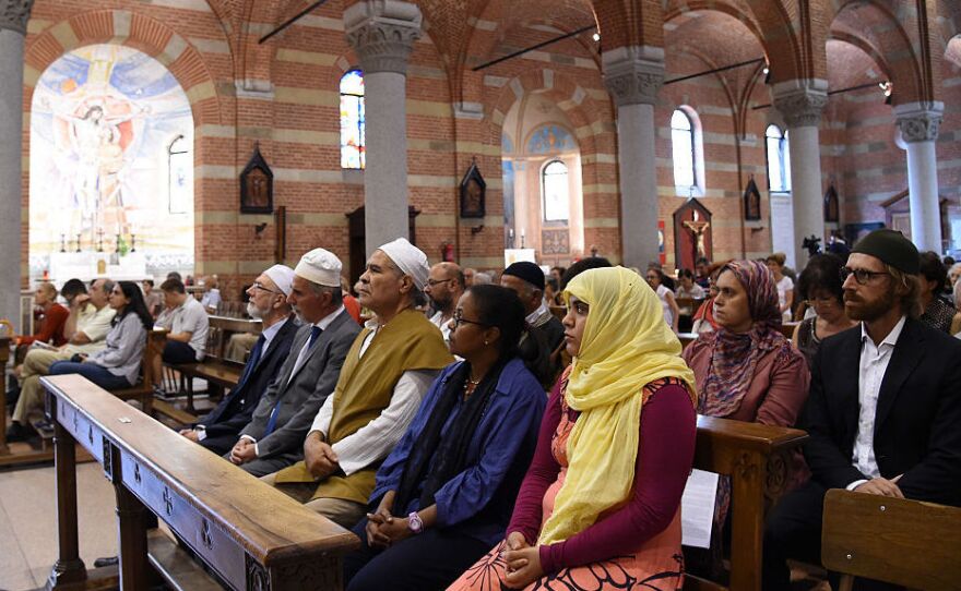 Members of the Muslim community attend a mass in the Catholic church of Santa Maria of Caravaggio on Sunday in Milan, Italy.