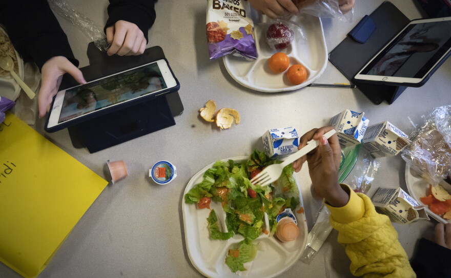 Seventh-graders sit together in the cafeteria during their lunch break at a public school in Brooklyn, N.Y., on Feb. 10, 2023.