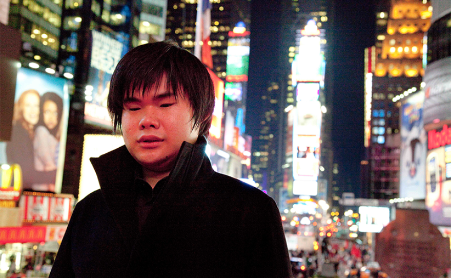 Nobuyuki Tsujii standing in Times Square in New York City. 