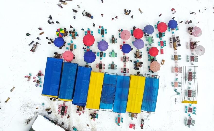 People dine alfresco at makeshift restaurants in the snowy valley of Kongdoori, Gulmarg, in India's Jammu & Kashmir.