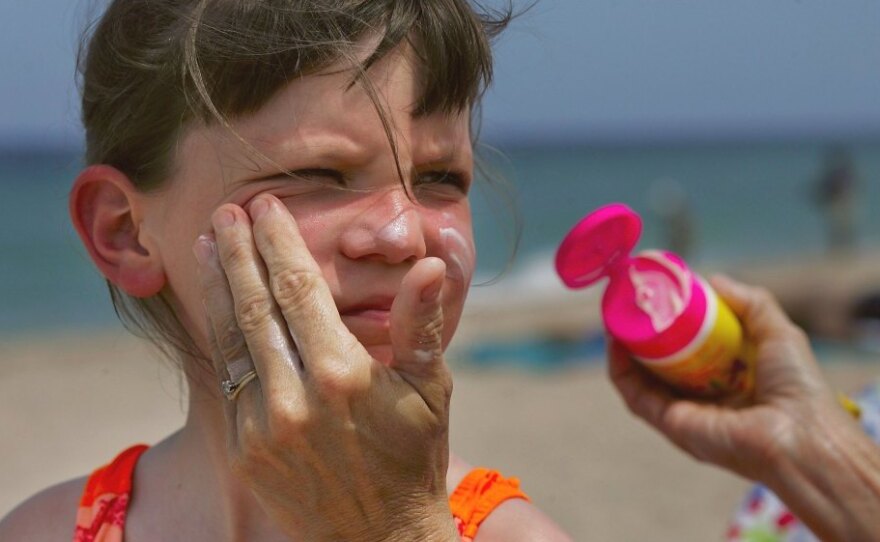 Savannah Stidham gets smeared with sunscreen during a visit to a beach in Fort Lauderdale, Fla., in 2006.