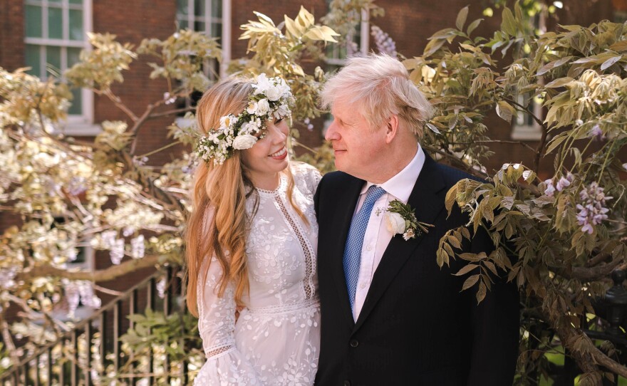 Prime Minister Boris Johnson poses with his wife Carrie Symonds in the garden of 10 Downing Street following their wedding at Westminster Cathedral on Saturday in London.