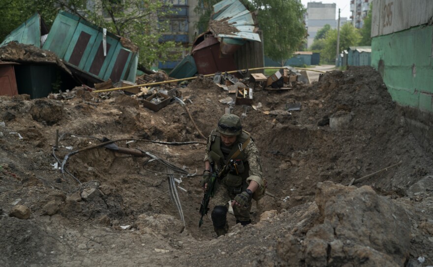 A special task force policeman inspects a site following an airstrike by Russian forces in Lysychansk, Luhansk region, Ukraine, on Friday.