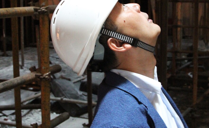 Jun Xia, an architect and Shanghai native, gazes up at a circular opening in the roof of Shanghai Tower. The architects hope to create "a vertical urban community" with the new building.