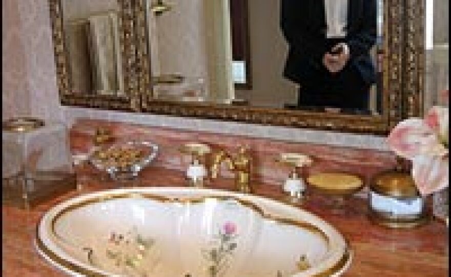 At a luxury villa in Sheshan, outside Shanghai, saleswoman Karen He shows a washbasin  decorated with 24-carat gold.