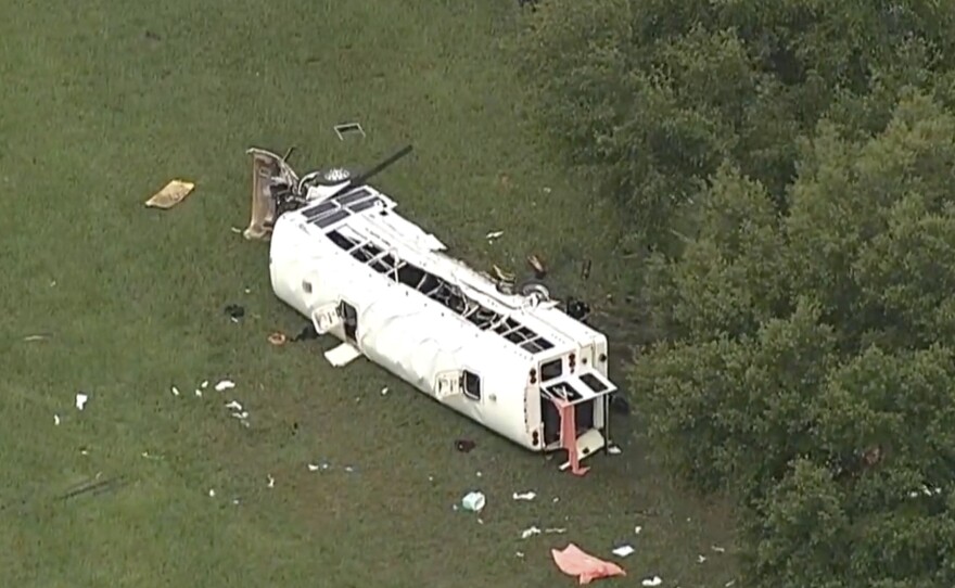 Emergency personnel work the scene of a deadly crash on Tuesday, in Marion County, Fla. The Florida Highway Patrol says a bus carrying farmworkers overturned, killing several people and injuring other passengers.