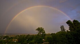 A rainbow materialized early Thursday evening after a day of rain. Seen from Mount Helix, across the valley of El Cajon.