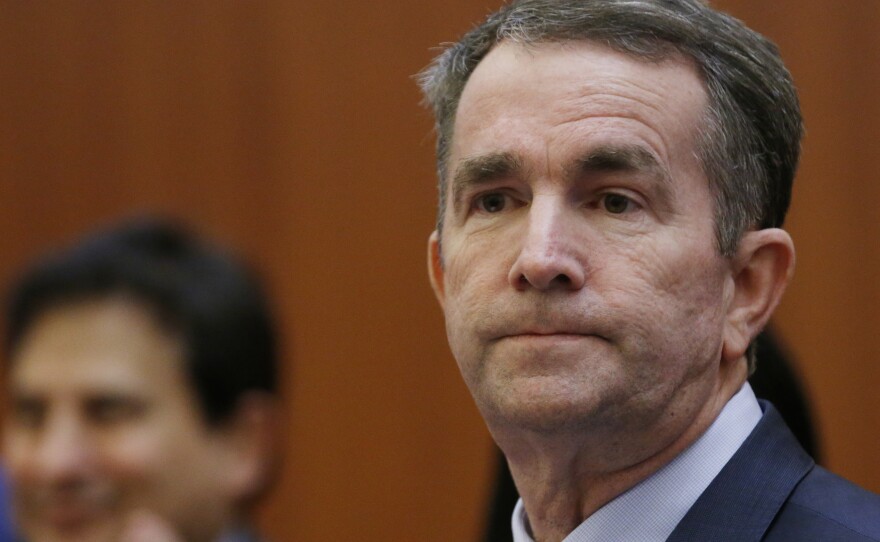 Virginia Gov. Ralph Northam, pictured preparing to address a news conference on Thursday, issued an apology for a racist photo on his medical school yearbook page.