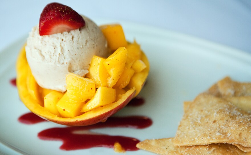 Diced mango tossed with lime juice and hot pepper and topped with coconut ice cream. Served with raspberry-wine reduction sauce and buñuelos.