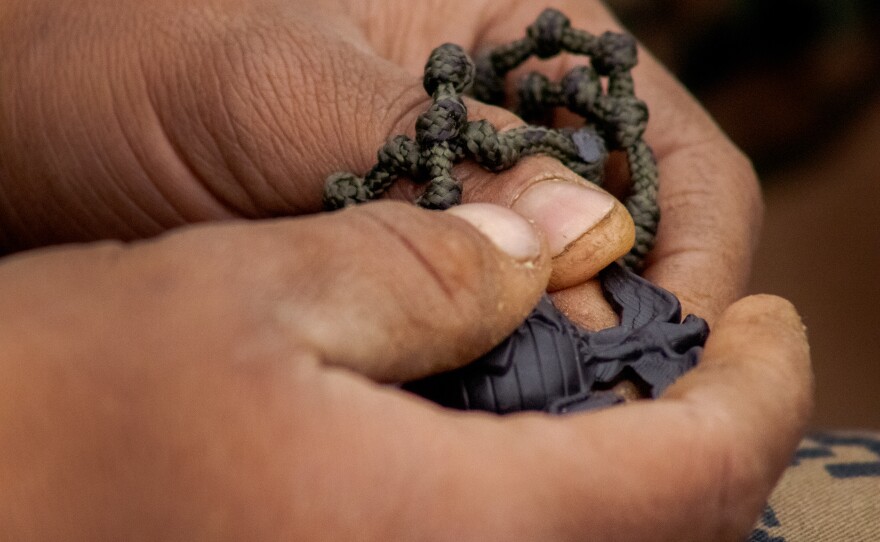 A Marine caresses the Eagle, Globe and Anchor pin she received for completing the Crucible, April 22, 2021.