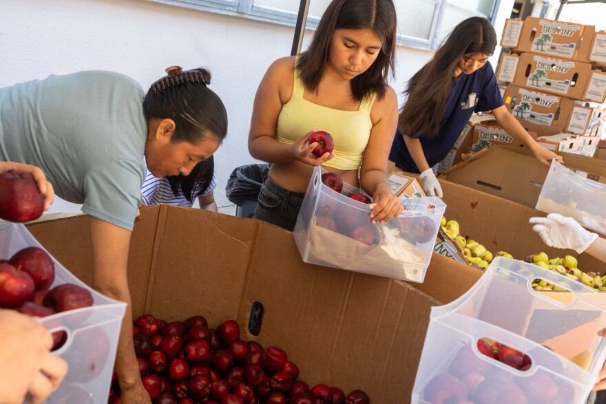 Student volunteers from Hoover High School work at the at school's food pantry, an initiative of the community schools program, July 18, 2023.