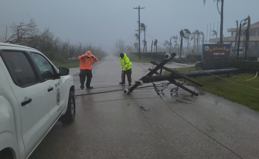 A utility pole blocks the road in Saipan on Wednesday as a super typhoon with ferocious winds and relentless rains, shredded tin roofs and forced residents to take cover from flying tree limbs.