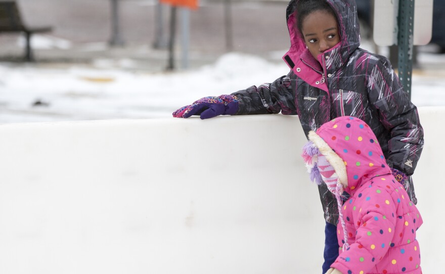 Brooklyn Hill, 3, got help from 10-year-old Thalia Epps on Tuesday as they skated in Ann Arbor, Mich. From the upper Midwest through New England, more bitter cold and stormy weather is expected in coming days.