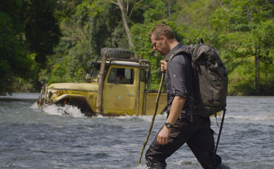 Chris Morgan crosses the river that separates the human camp from the orangutan camp, Jantho Nature Reserve, Aceh, Sumatra, Indonesia.