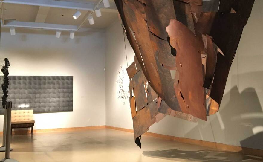 Another view of Kline Swonger's "Crossing the Line" sculptural installation. The chair and charcoal works in the background are by Marisol Rendón.