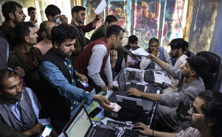 Afghan Special Immigrant Visa (SIV) applicants crowd into the Herat Kabul Internet cafe to apply for the SIV program on August 8, 2021 in Kabul, Afghanistan.