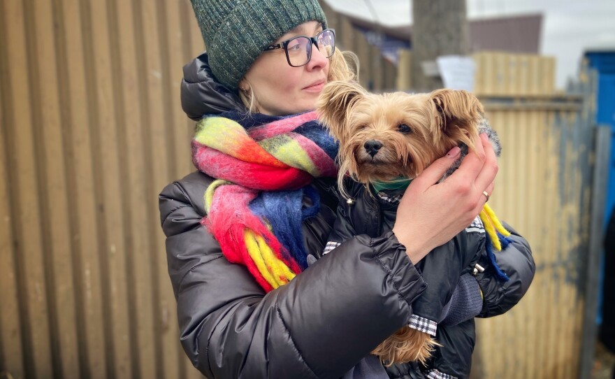 Evgenia holding her dog Kienia at Medyk border crossing in southeast Poland.