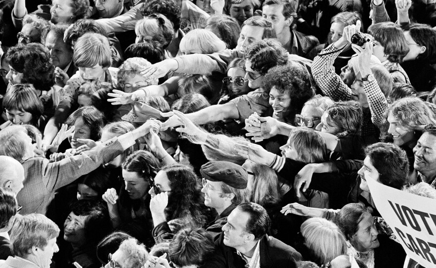A crowd surges forward as Jimmy Carter shakes hands following a political rally in San Francisco on Oct. 31, 1976.