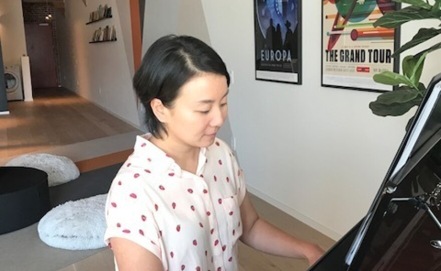 Lu plays the piano in her loft in downtown LA. She's currently working on a book about Mozart's sister, Maria Anna.