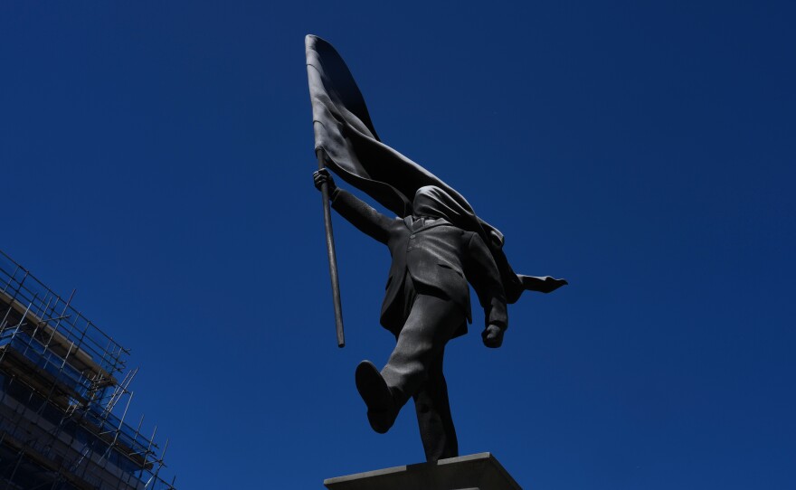 A statue of a man holding a flag covering his face, and signed 'Banksy', which has appeared in Waterloo Place in London, Thursday, April 30, 2026.