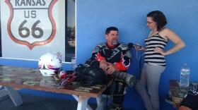 Dudley Pratt (left) talks to reporter Jenny Gold at a gas station in Fenner, Calif. He's frustrated by all the paperwork related to his health insurance these days.