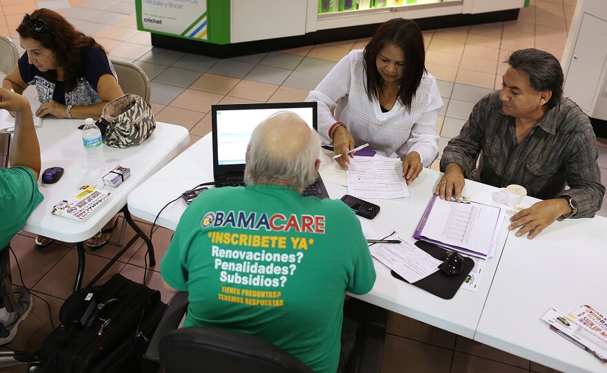 (Left to right) Martha Lucia, Bienvendida Barreno and Jorge Baquero went to a Miami mall in early November to discuss health insurance options with agents from Sunshine Life and Health Advisors.