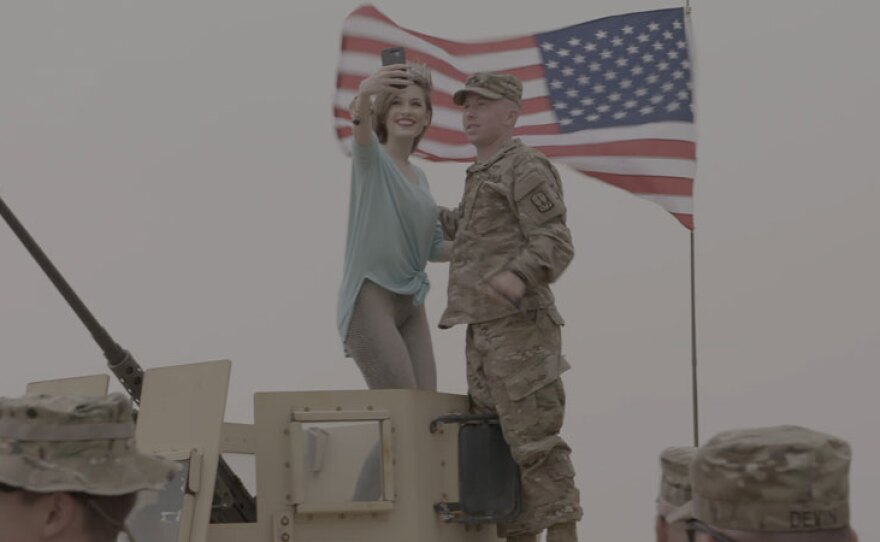 Miss America takes a selfie with a soldier in Kuwait.