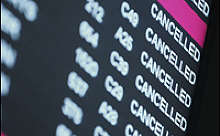 A departure board shows multiple cancelled announcements at Denver International Airport Friday.