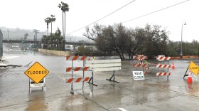Traffic signs placed on flooded roads in Mission Valley during a winter storm, Feb. 14, 2019. 


