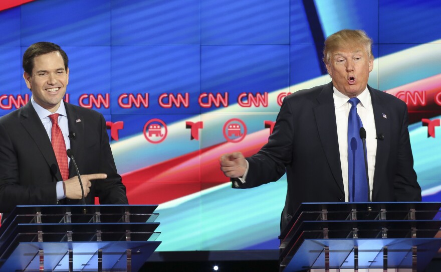 Florida Sen. Marco Rubio mockingly smiles and points toward Donald Trump during the last Republican presidential debate before Super Tuesday. Rubio hopes to pick off some states.
