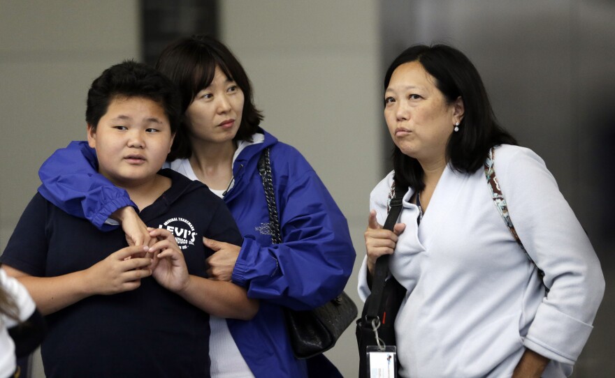 Friends and relatives await updates outside the Reflection Room at the airport.