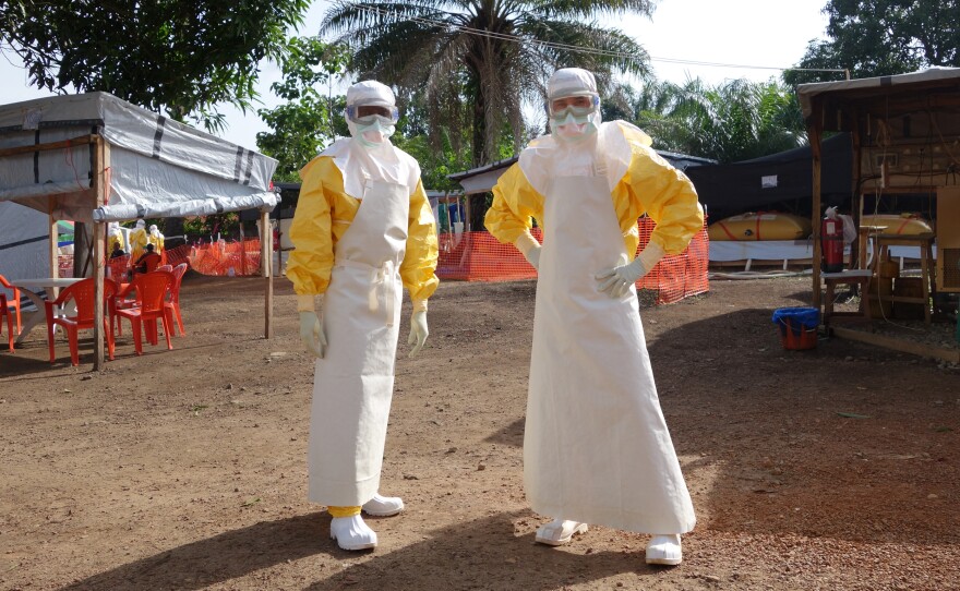 Dr. William Fischer of Doctors Without Borders prepares to treat Ebola patients with a colleague in Gueckedou, Guinea, the epicenter of the outbreak.